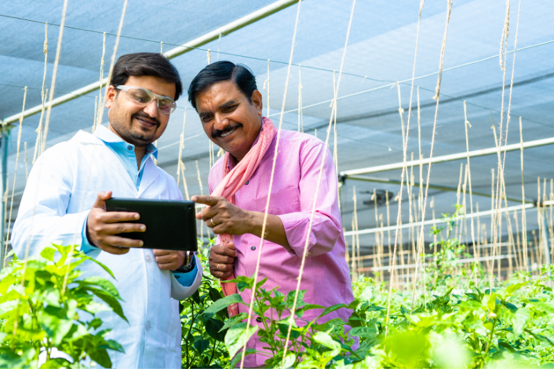 Two farmers discussion tech tools for farming