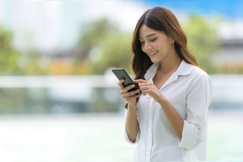 a girl laughing on watching video on social media