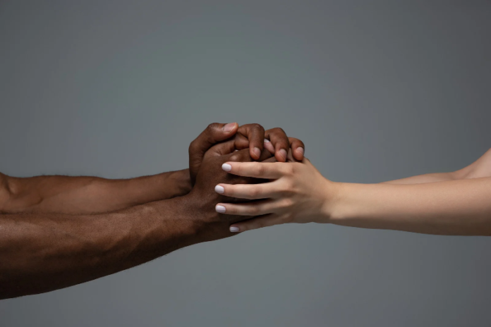 Two people holding hand as a gesture of respect